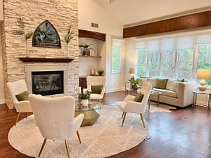 A living room with white design elements to appease the concept of neuroaesthetics.